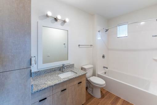 A bathroom with a sink, toilet, and bathtub.