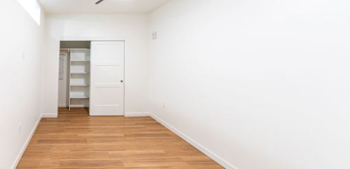 A room with a white door and a white wall.