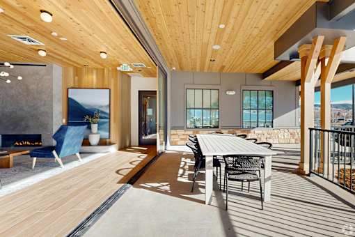 A modern dining area with a wooden table and chairs.