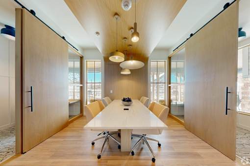 A conference room with a long table and chairs.