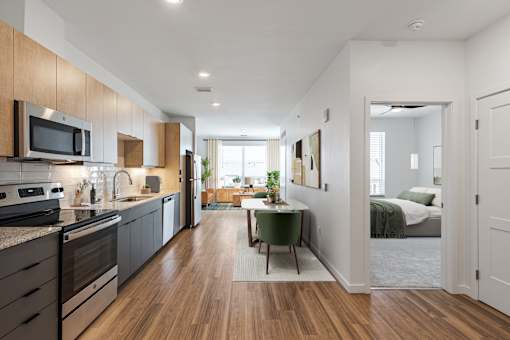 an open kitchen and dining area with a bedroom in the background