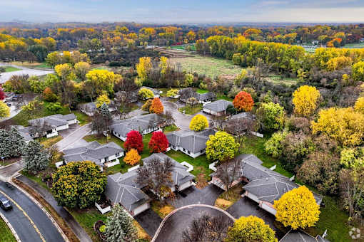 A suburban neighborhood with houses and trees in autumn colors.