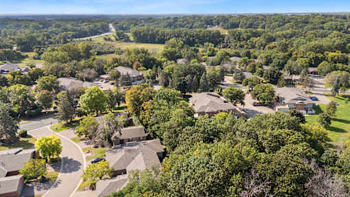 A bird's eye view of a residential area with houses and trees.