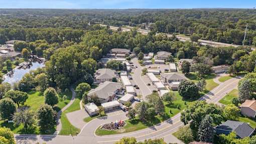 A bird's eye view of a residential area with houses and a river.