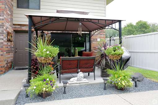 A patio with a table and chairs under a canopy.
