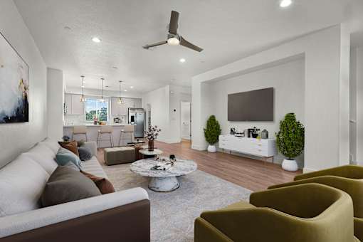 A living room with a white couch, a grey coffee table, and a brown armchair.