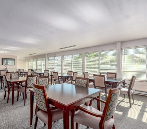 A conference room with a long table and chairs.