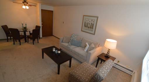 A living room with a couch, chair, and coffee table.