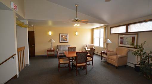 A room with a table and chairs in it.