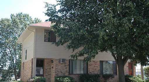 A house with a tree in front of it.