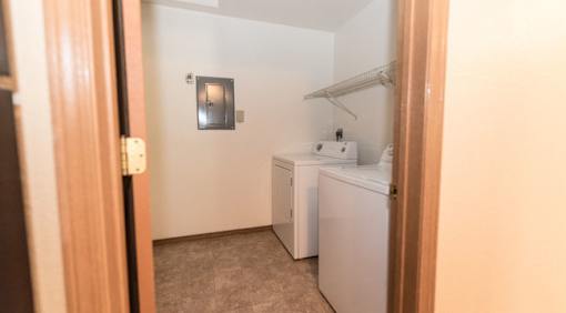 A small laundry room with a washer and dryer.