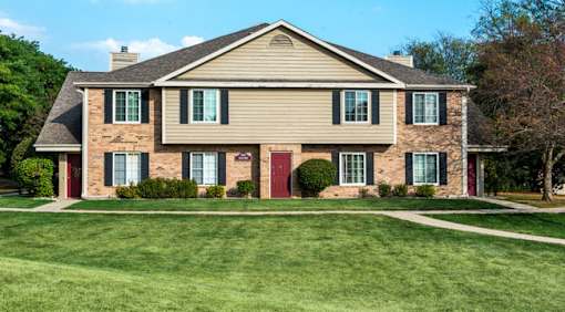 A house with a red door and green shutters.