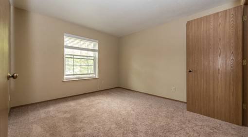 A room with a window and a door.