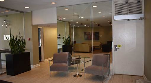 A glass wall separates the office from the hallway.