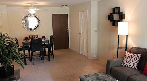 A living room with a grey couch and a black table.