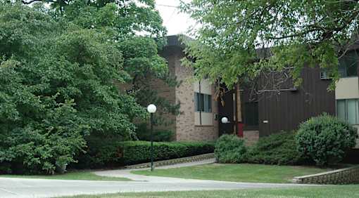 A building with a green lawn in front.