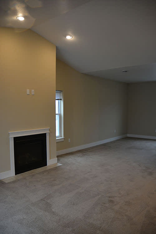A room with a fireplace and a window.