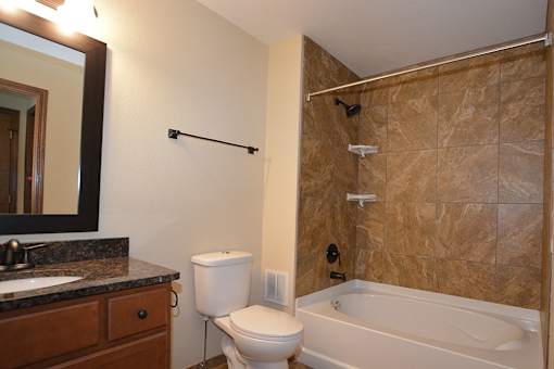A bathroom with a toilet, sink, and bathtub.