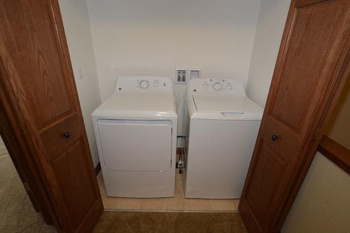 A small laundry room with a washer and dryer.