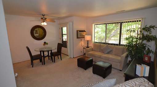 A living room with a couch, chair, and table.