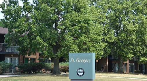 A sign for St. Gregory stands in front of a building.