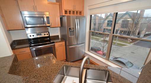 A kitchen with granite countertops and stainless steel appliances.