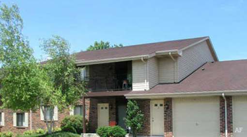 A house with a brown roof and a garage door.