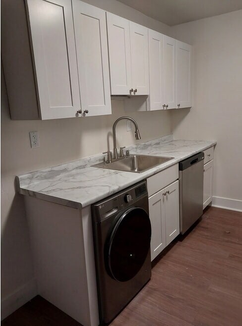 A small laundry room with a washer and dryer.