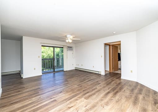 A room with wooden floors and white walls.