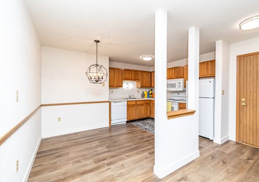 A kitchen with wooden cabinets and a white fridge.