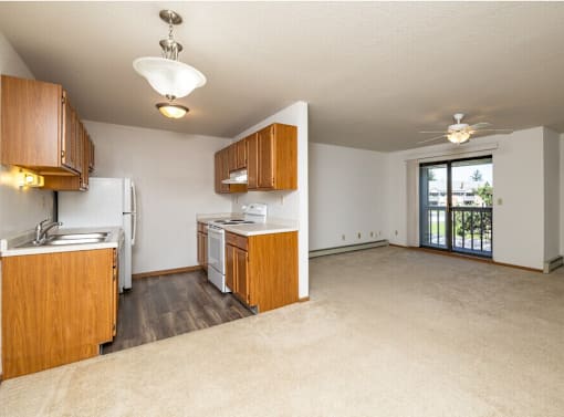 A kitchen with wooden cabinets and a refrigerator.