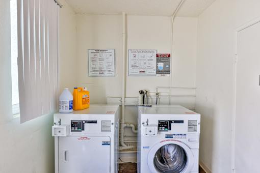 A small laundry room with a washer and dryer.