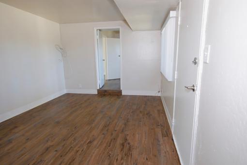 A room with wooden floors and white walls.