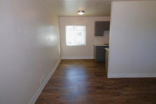 A room with wooden floors and a window.