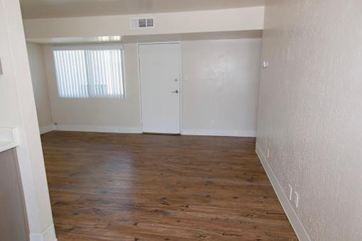 A room with wooden floors and white walls.
