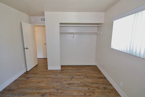 A room with a wooden floor and white walls.