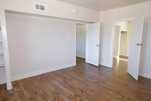A room with white walls and wooden flooring.