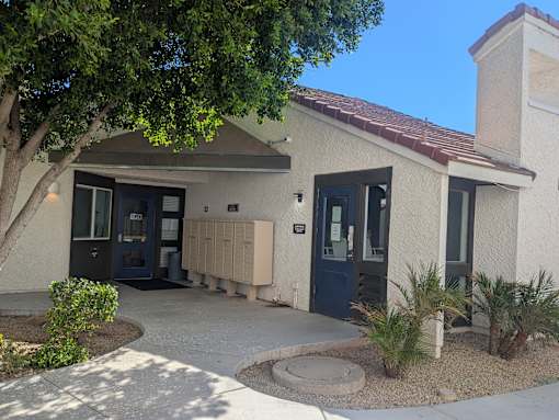 A house with a blue door and a brown roof.