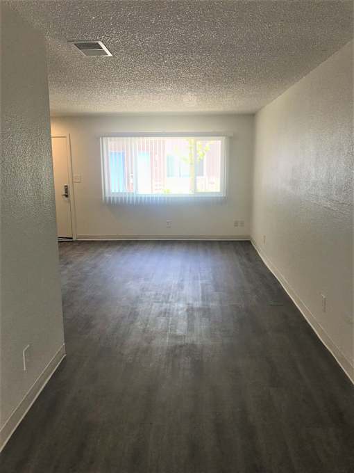 A room with a window and a door.