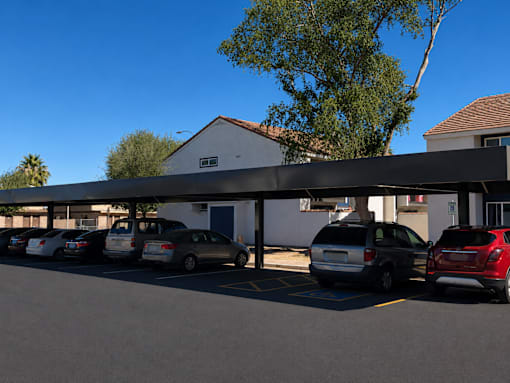 A parking lot with cars parked under a covered area.