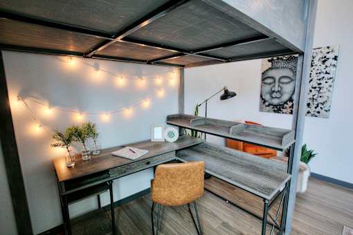 Modern workspace with desk and string lights at The Traveler Apartments, Omaha, Nebraska