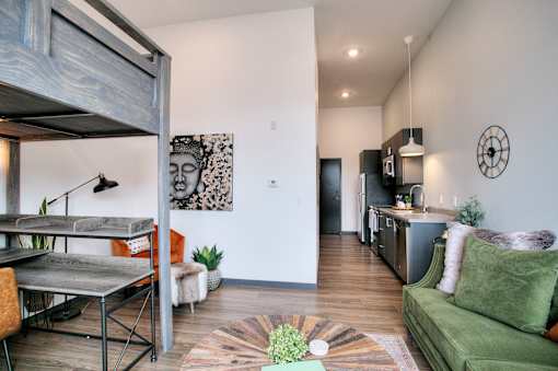 Open concept living area with modern kitchen at The Traveler Apartments, Omaha, NE 68131
