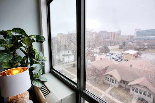 City view from apartment window with indoor plant at The Traveler Apartments, Nebraska