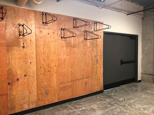 Bike storage wall with multiple mounting racks at The Traveler Apartments, Omaha, NE 68131