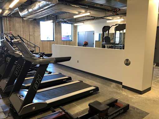 Fitness center with treadmills and strength equipment at The Traveler Apartments, Omaha, NE