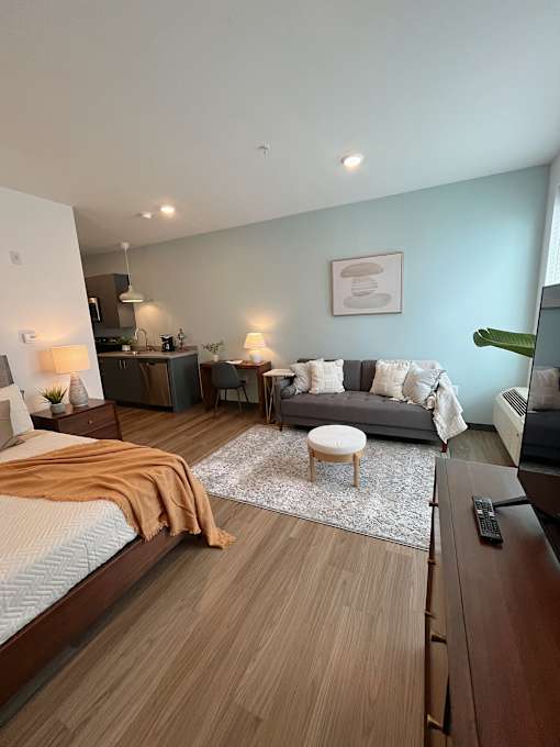 Studio apartment with kitchenette and living space at The Traveler Apartments, Omaha, NE 68131