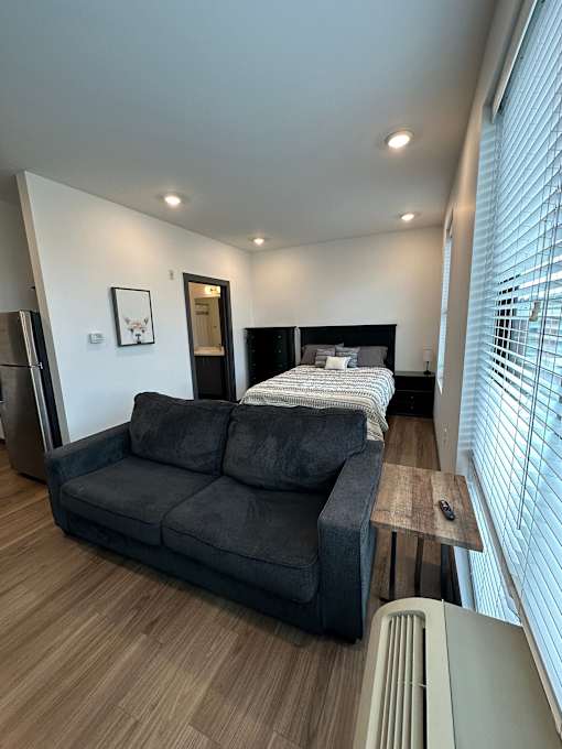 Studio apartment with bed and sofa living space at The Traveler Apartments, Omaha, 68131