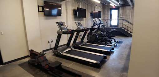 Cardio equipment area with treadmills and ellipticals at The Traveler Apartments, Omaha, Nebraska