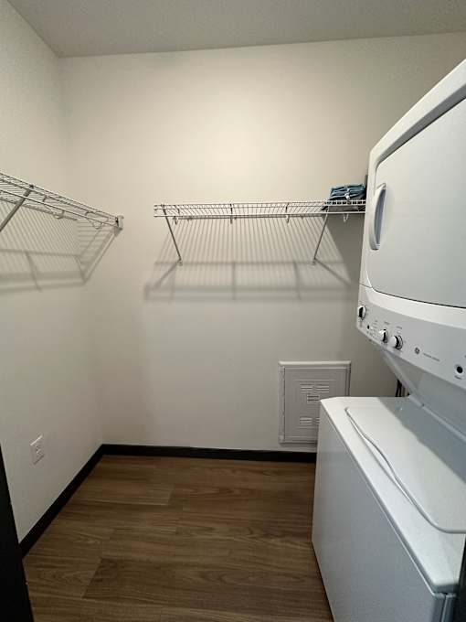 Laundry room with stackable washer and dryer at The Traveler Apartments, Nebraska, 68131