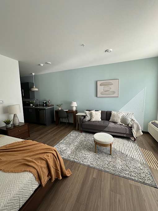 Spacious studio with daybed and kitchenette at The Traveler Apartments, Omaha, Nebraska